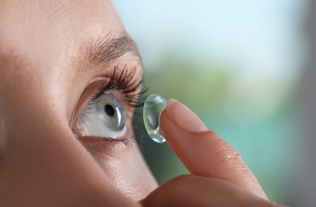 Close up of a person putting a contact lens into their eye